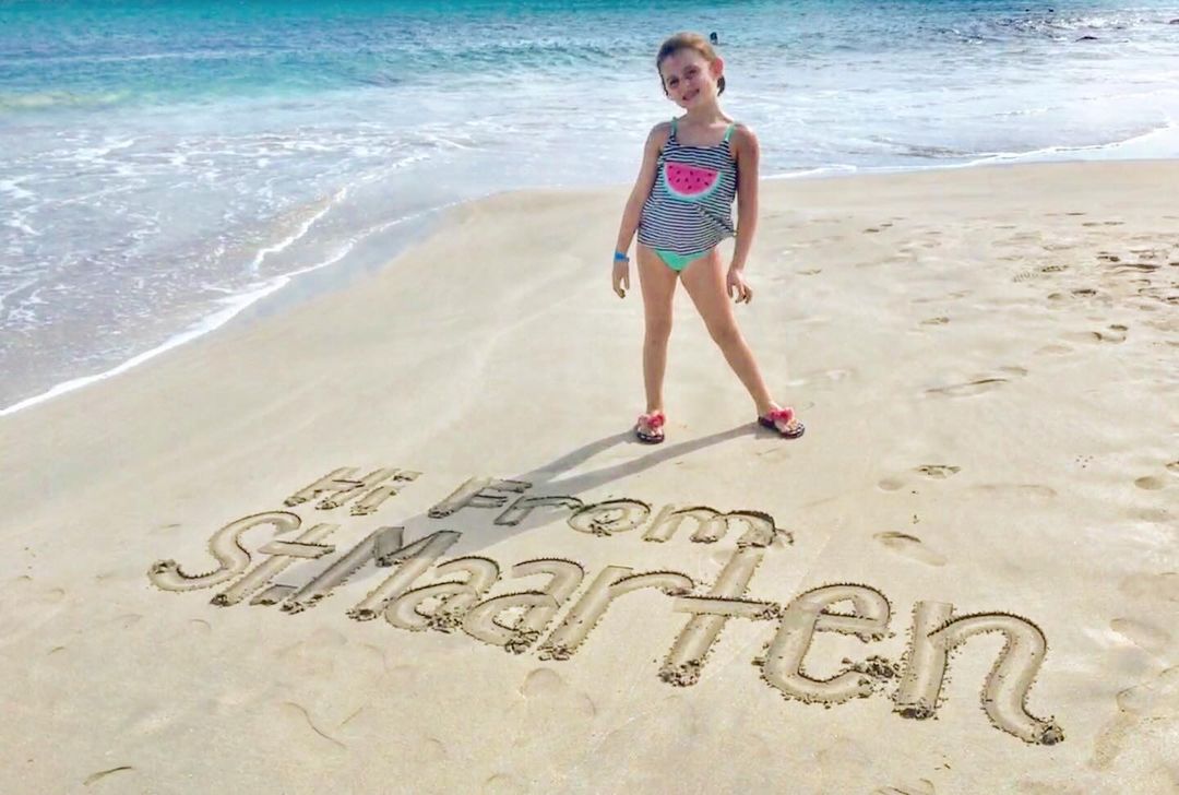 a girl standing on a beach