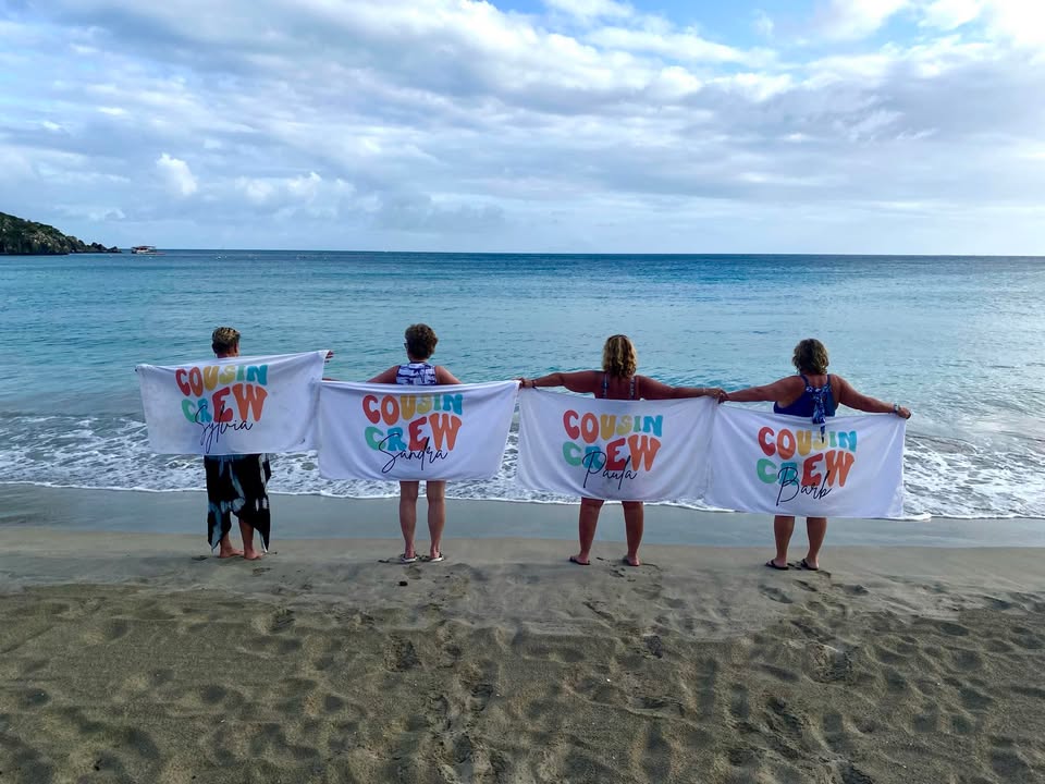 a group of people holding white towels on a beach