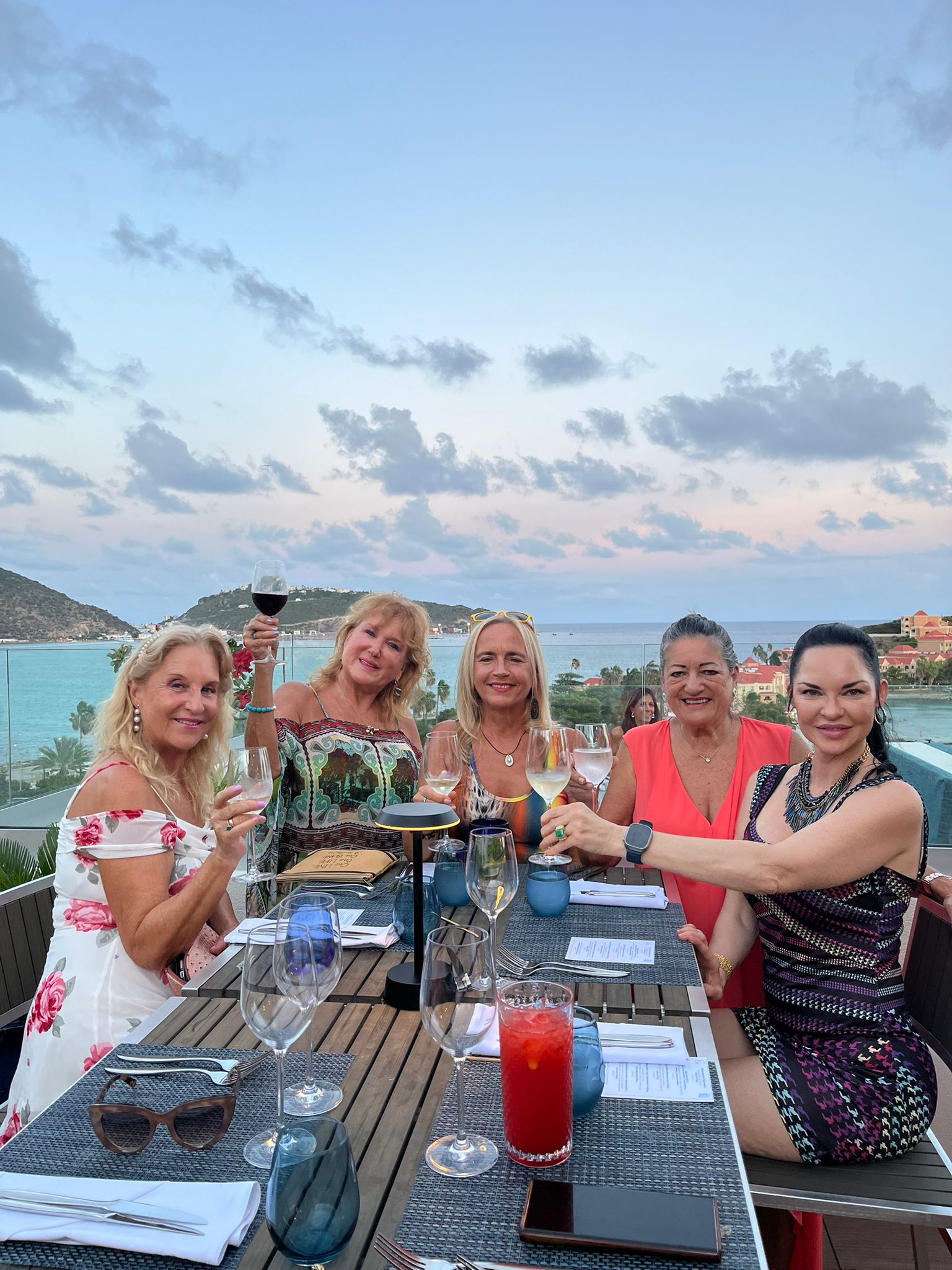 a group of women sitting at a table with drinks