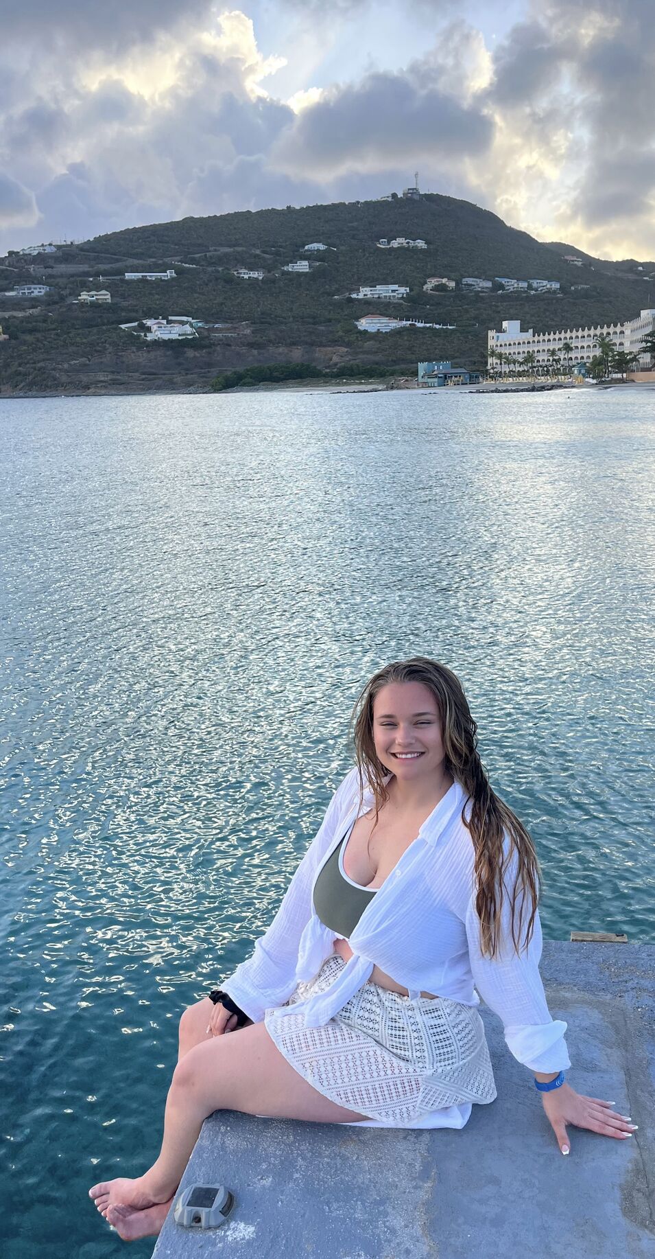 Woman sitting at the end of a pier